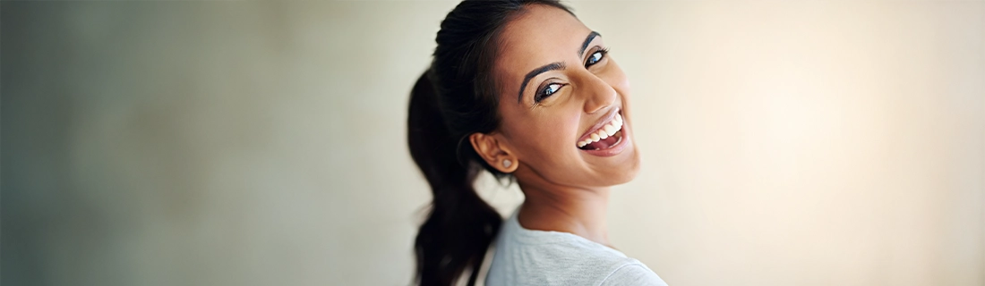 Dentist Merrimack NH Smiling Woman Looking Over Shoulder