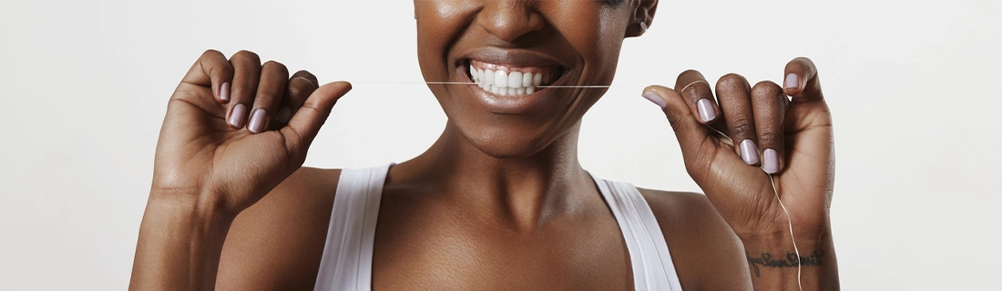 Dentist Merrimack NH Woman Flossing Teeth